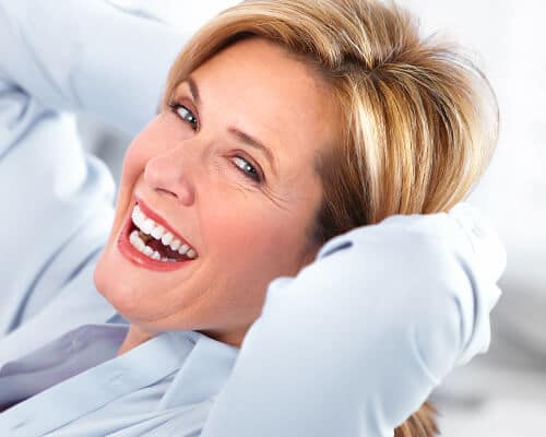 Woman with white filling smiling confidently