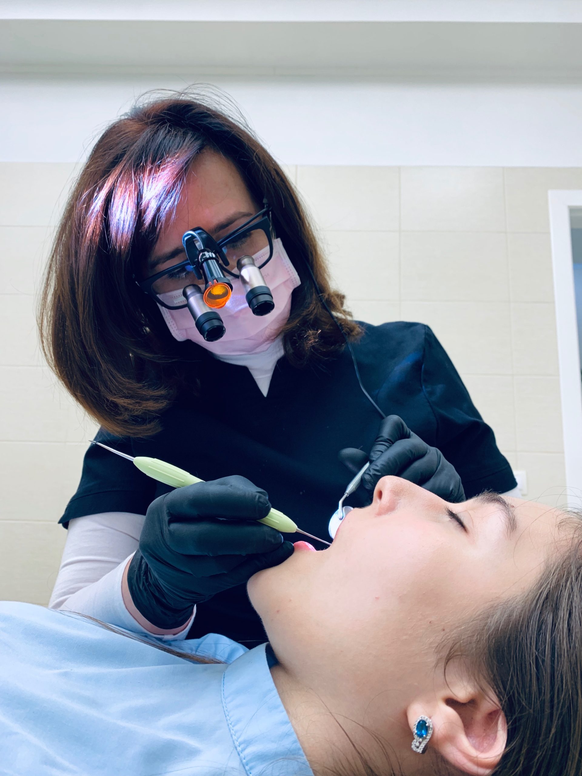 Female Dentist checking Teeth