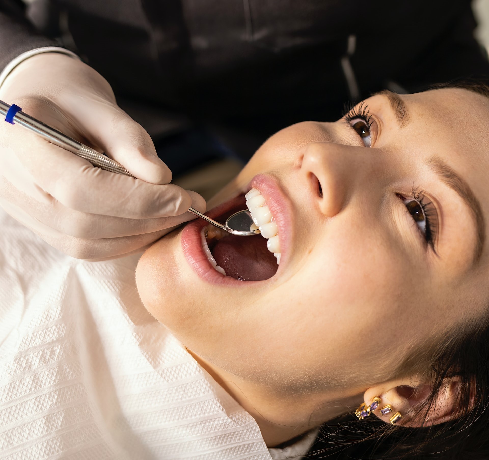 Special Offers Dentist examining the patients teeth.