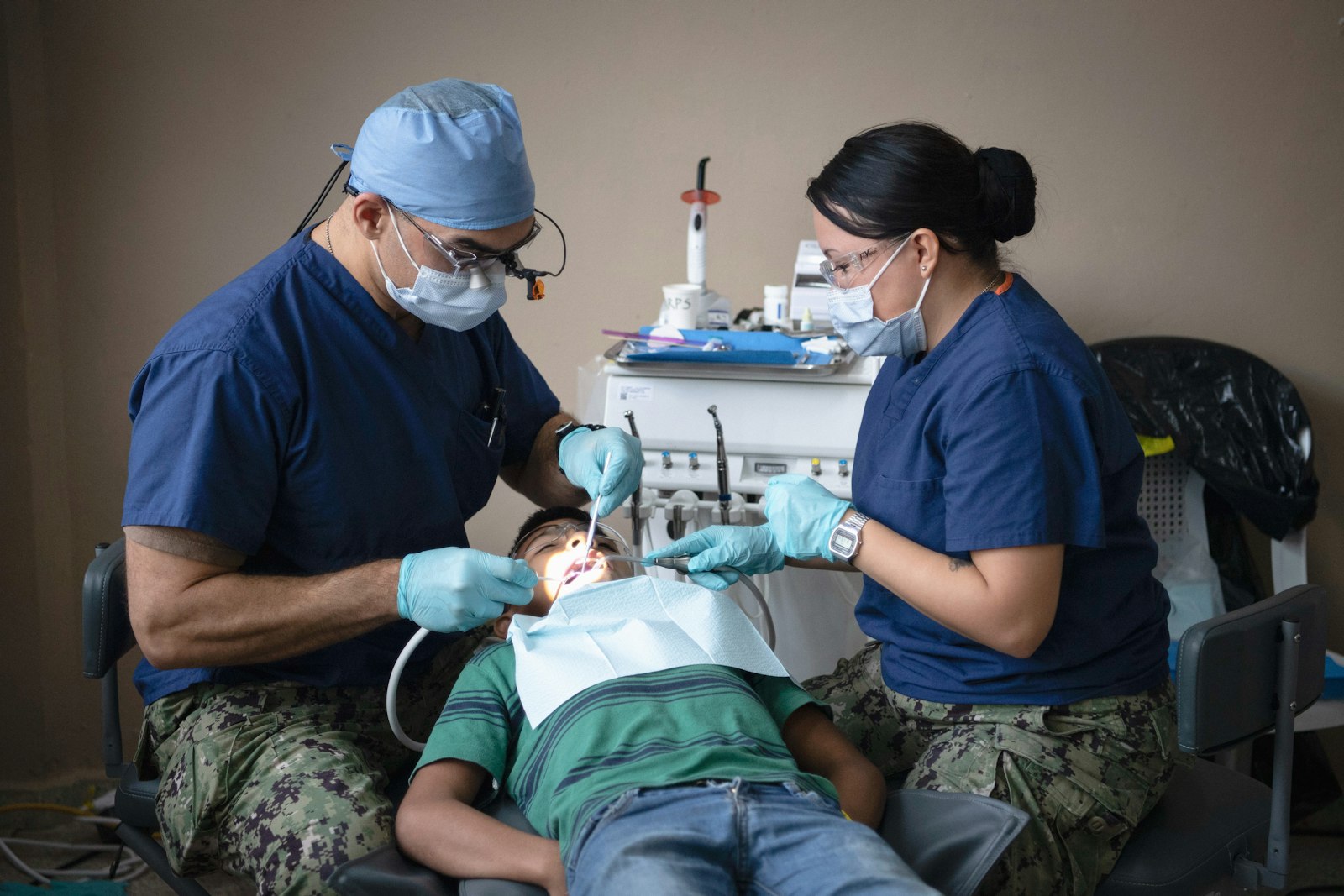 Dentists providing dental care to a patient